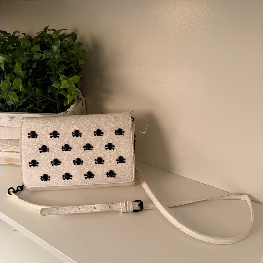 Betsey Johnson White Faux Leather Crossbody Bag with Black Skull Studs.